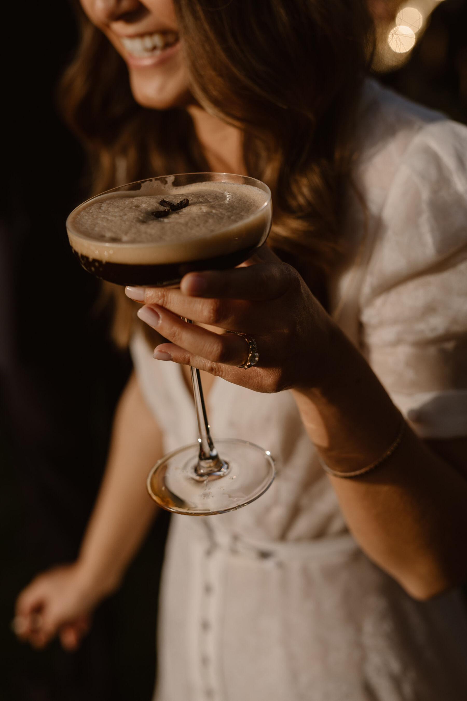 Bride holding a cocktail. Dewsall Court wedding. Agnes Black Photography.