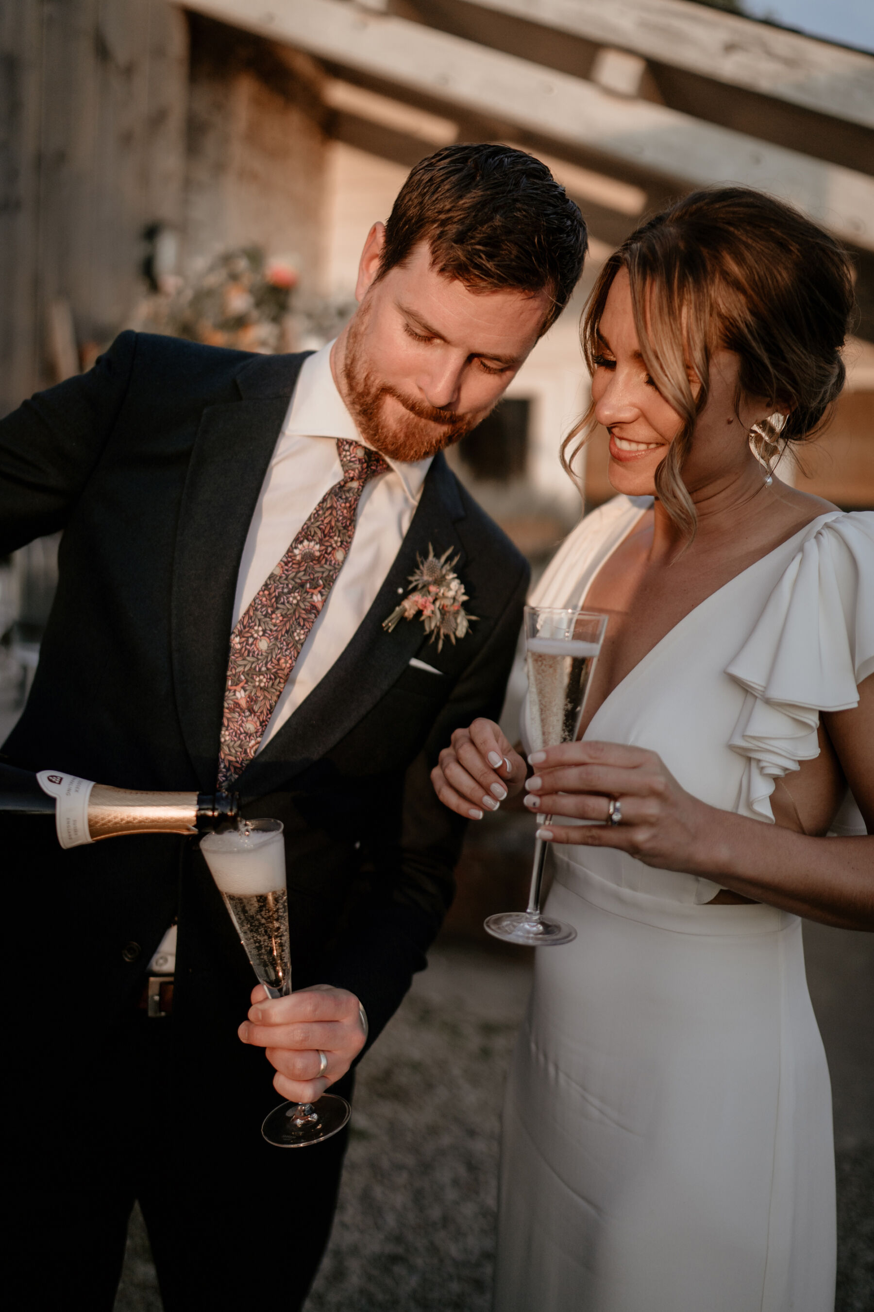 Bride and groom pouring champagne