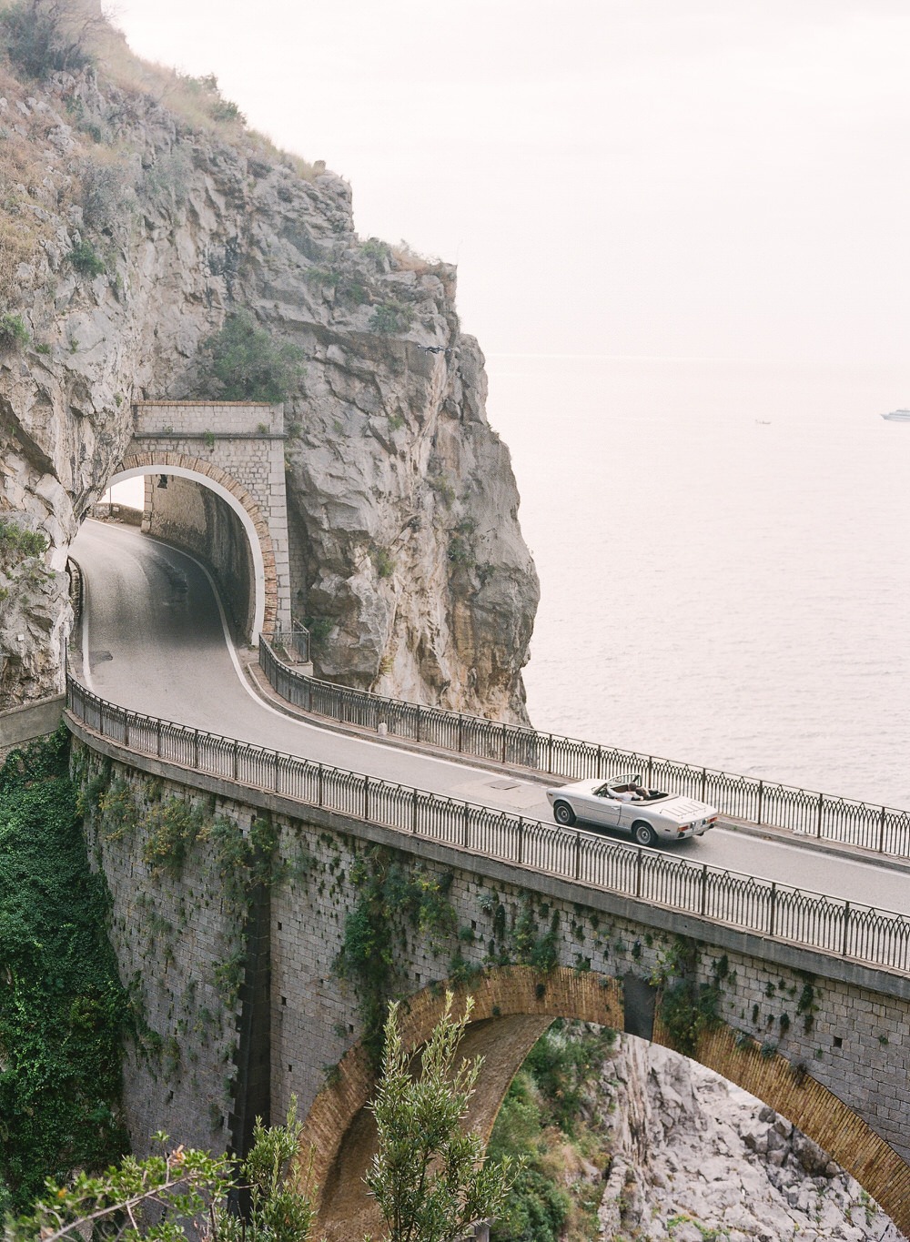 cruising along the Amalfi Coast in a vintage car