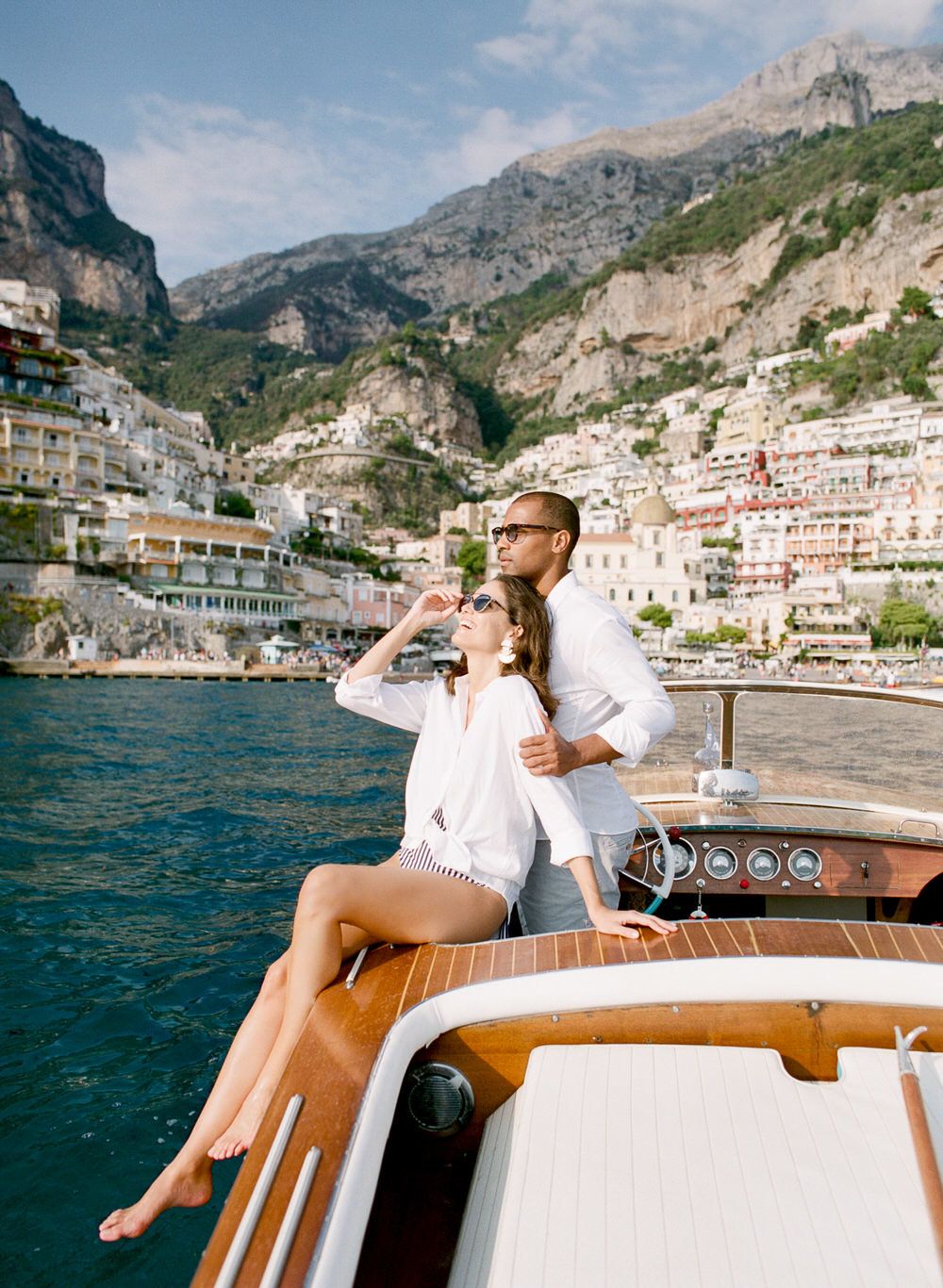 newlyweds laughing on boat in Positano