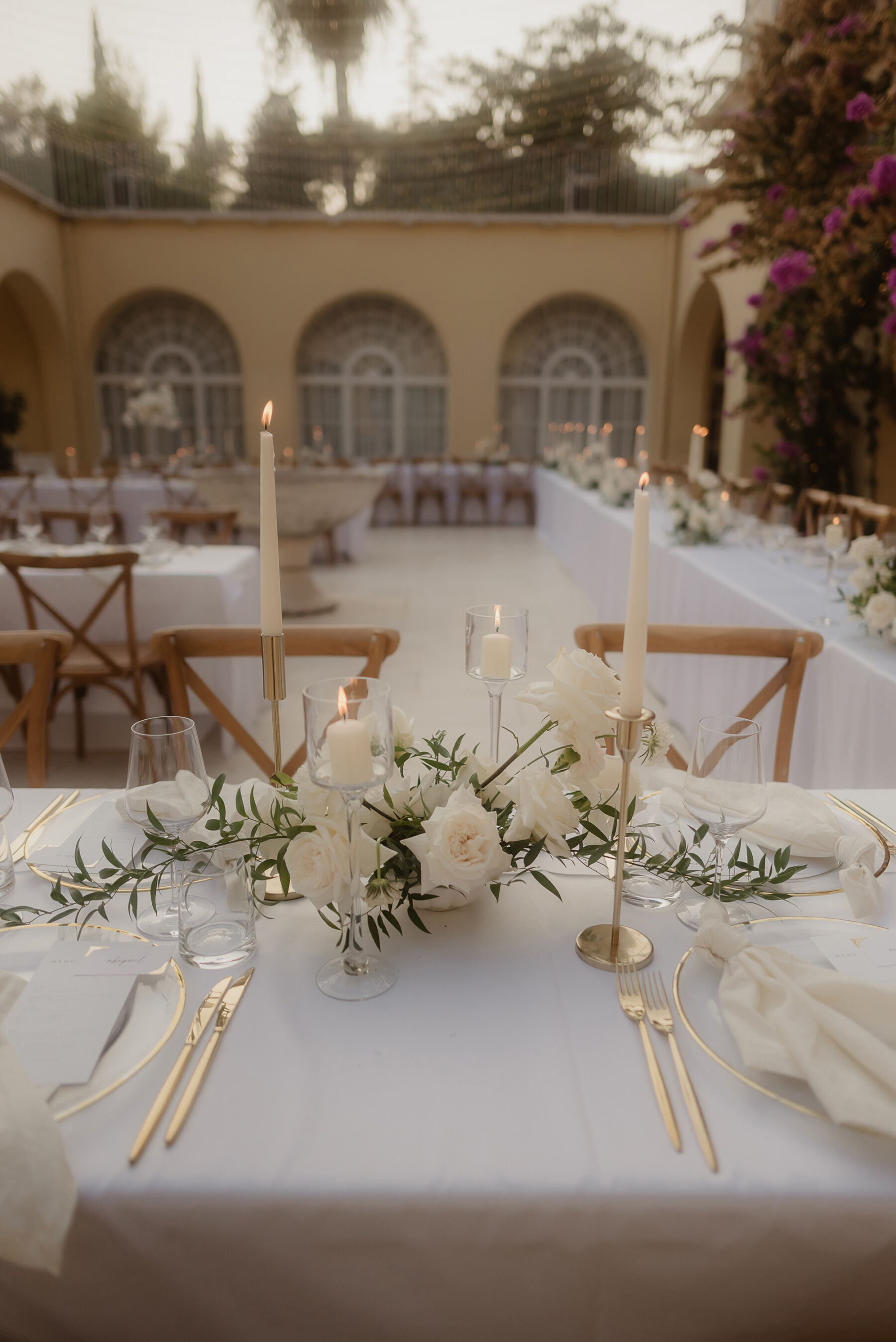 Sarah in Eva Lendel for her Classy & Contemporary Wedding in Croatia 42 White taper candles and elegant white table flowers, white table linen and crossback chairs, wedding reception in Croatia