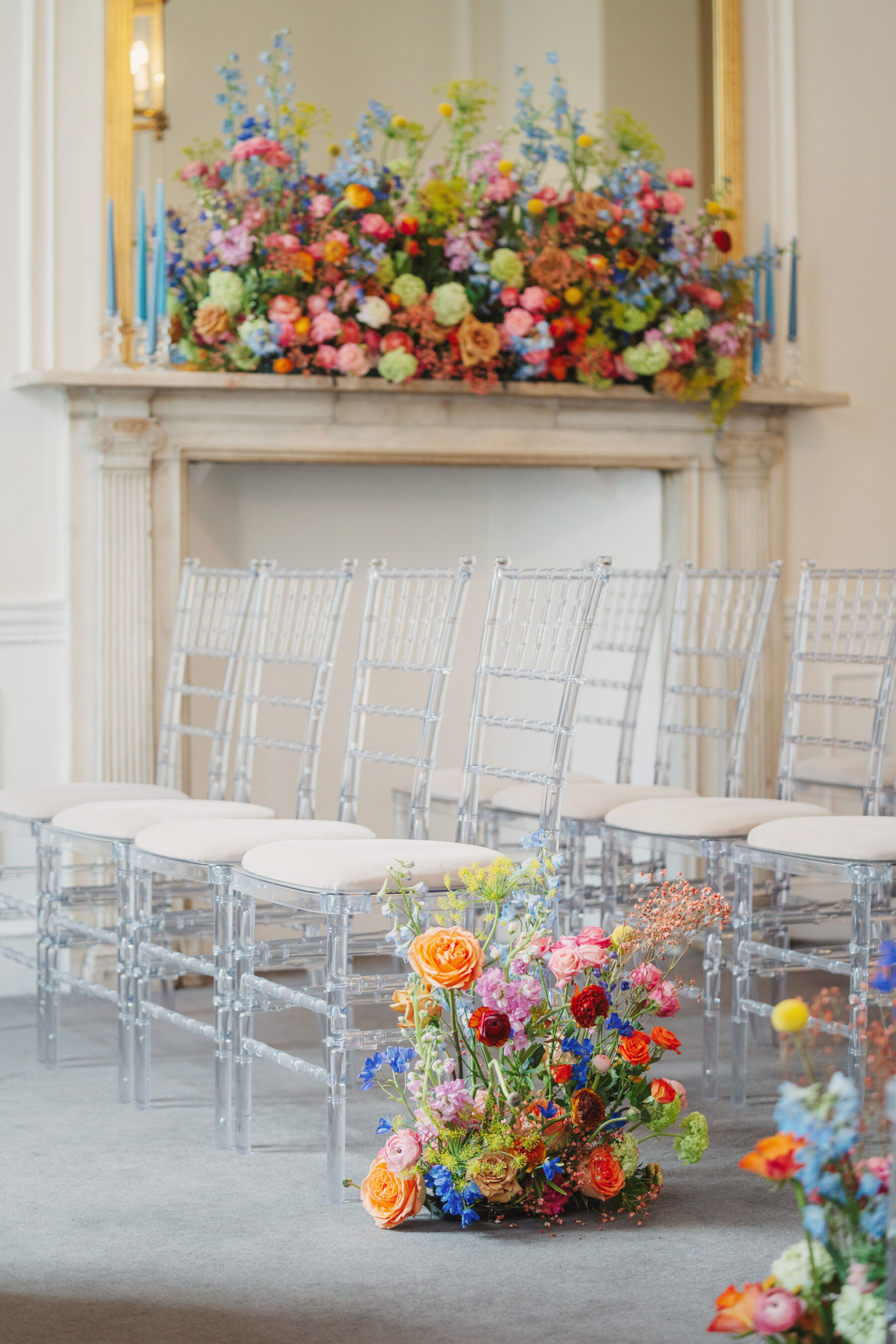 How to Create a Beautiful Sustainable Wedding on a Small Budget, with 41 Portland Place, London 23 Bright and colourful wedding flowers decorating the end of the aisle and fireplace.