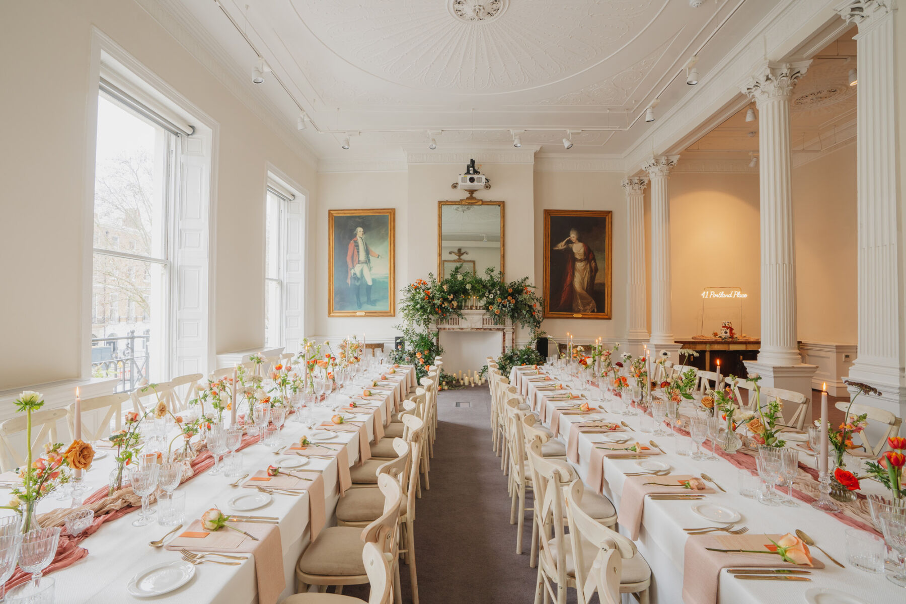 How to Create a Beautiful Sustainable Wedding on a Small Budget, with 41 Portland Place, London 3 Light, bright and airy wedding reception room at 41 Portland Place London, decorated in burnt orange flowers and table decor.