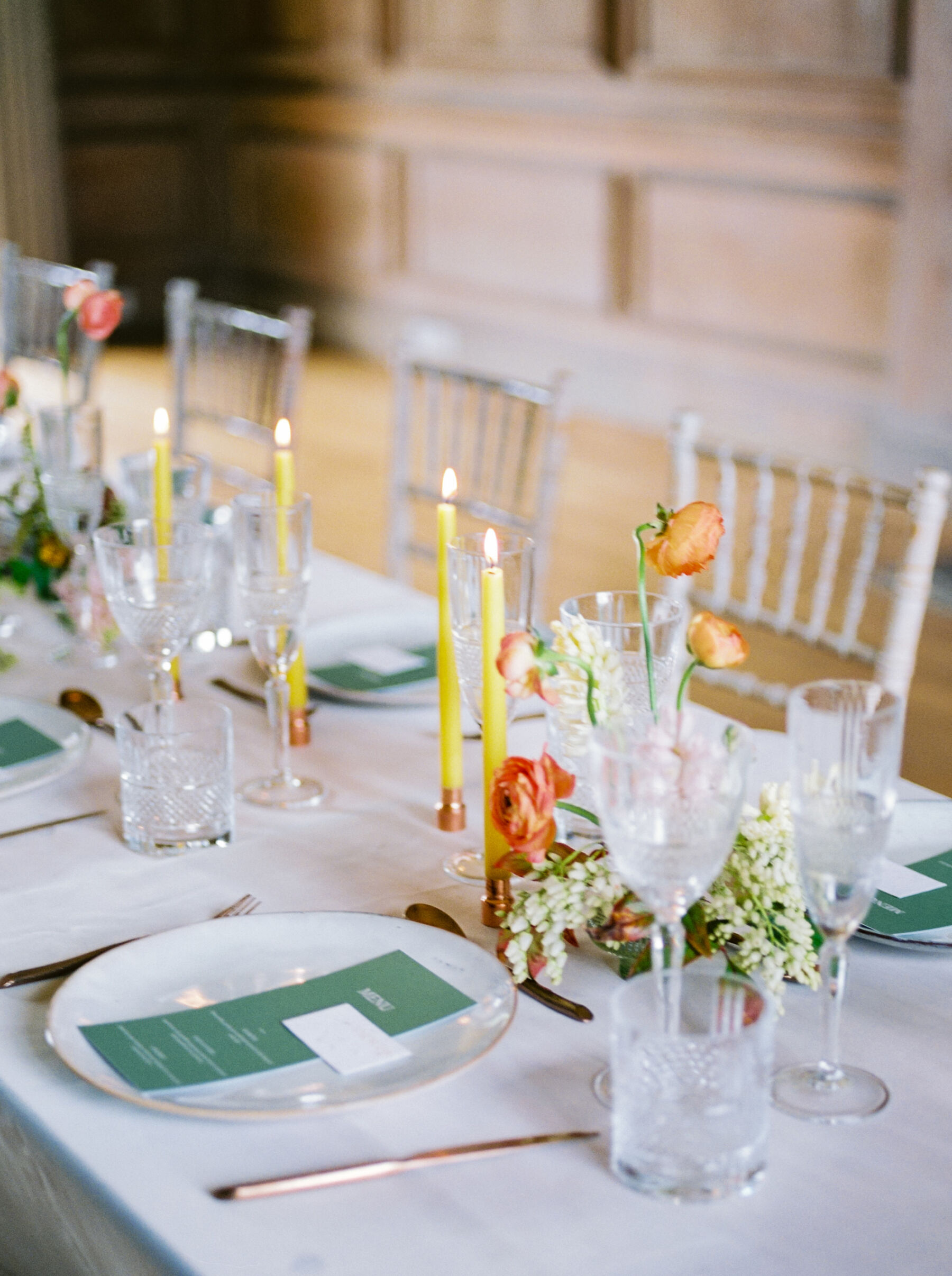 Celebrating Seasonal, British Grown Wedding Flowers With Flower & Fern at Findon Place 21 Chatreuse tapered candles on a table with elegant British grown wedding flowers.