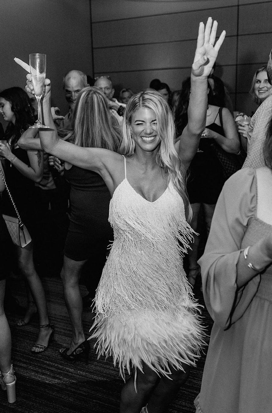 woman showing how to plan a rehearsal dinner with fun dance floor ideas