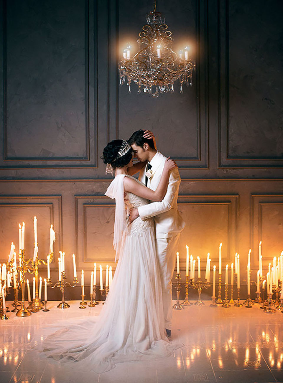 bride and groom dancing around candles for a winter wedding