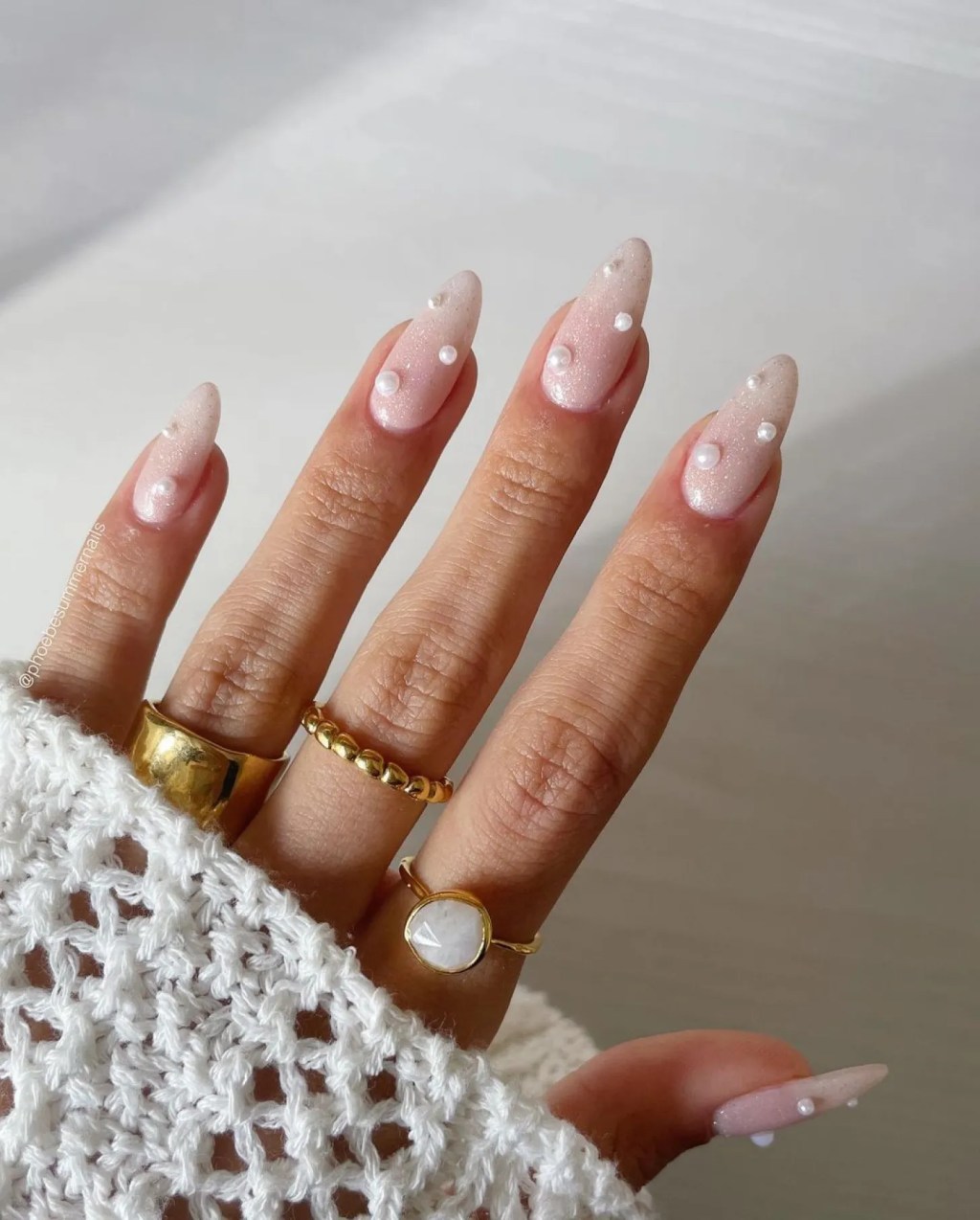 elegant sparkly white manicure with 3D pearl details
