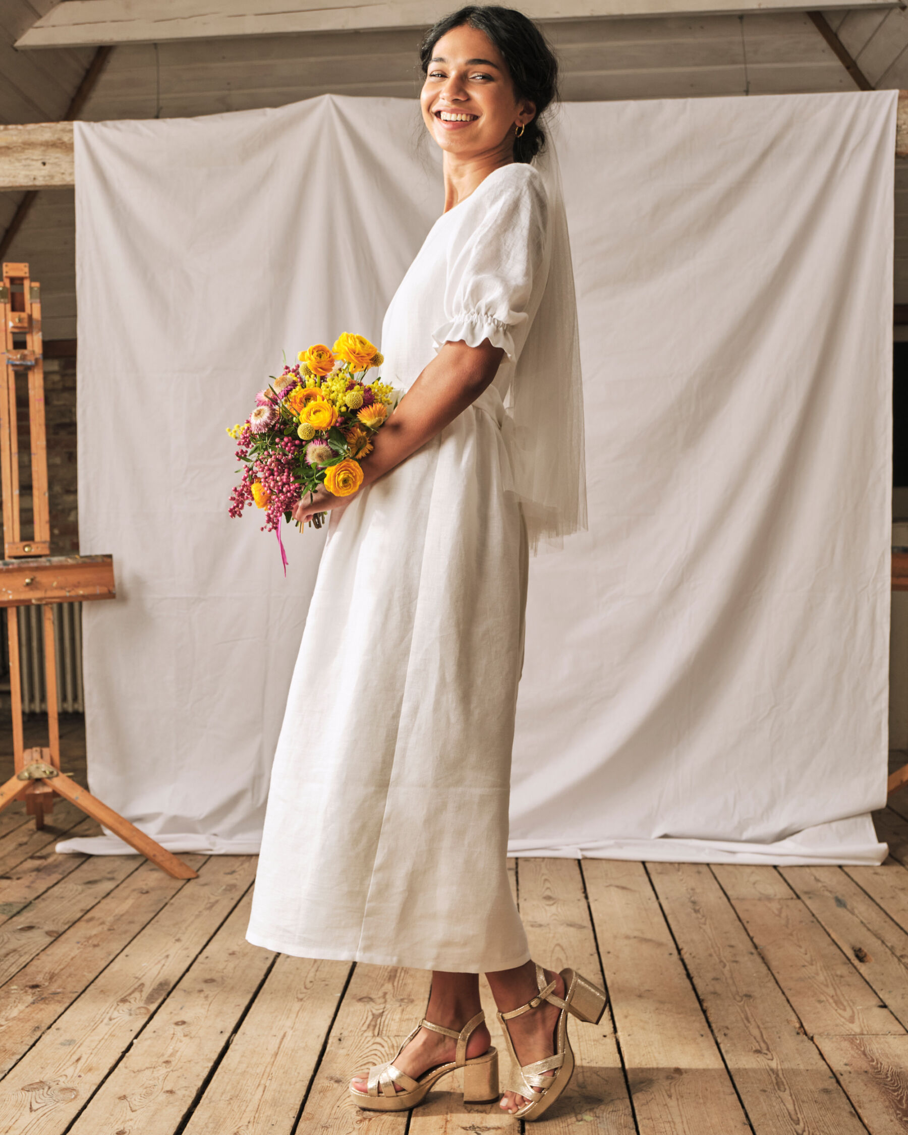 Modern bride in a tea length wedding dress with gold block heels. Sophie Rose Bridal