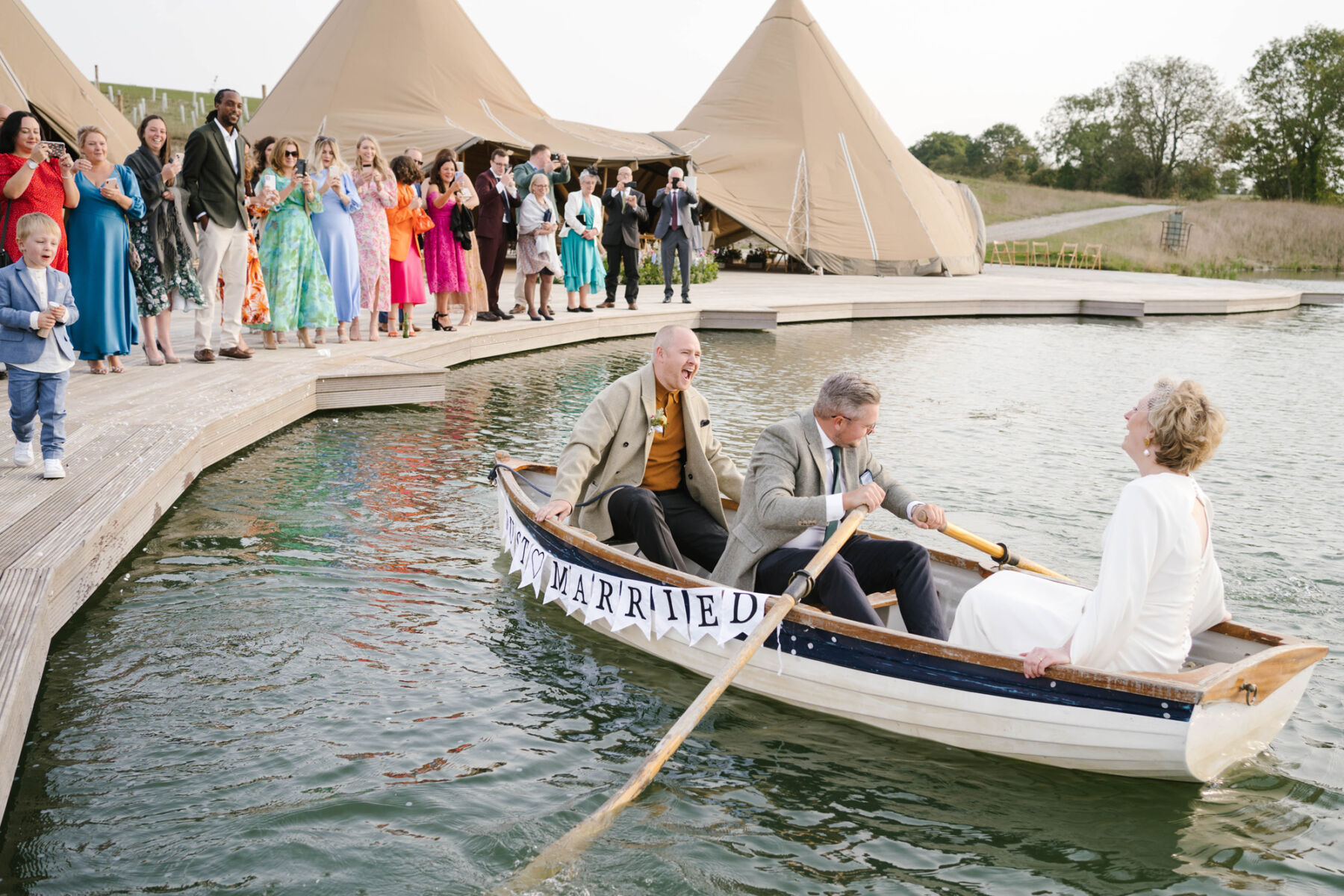 Bride & groom in a boat at Wilderness Reserve wedding venue Suffolk