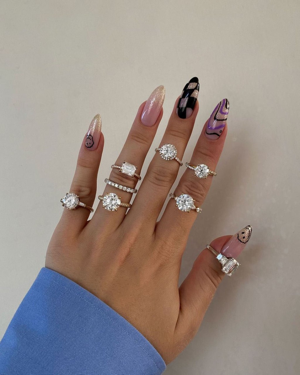 hand wearing a collection of James Allen classic round diamond rings best places to buy engagement rings for women