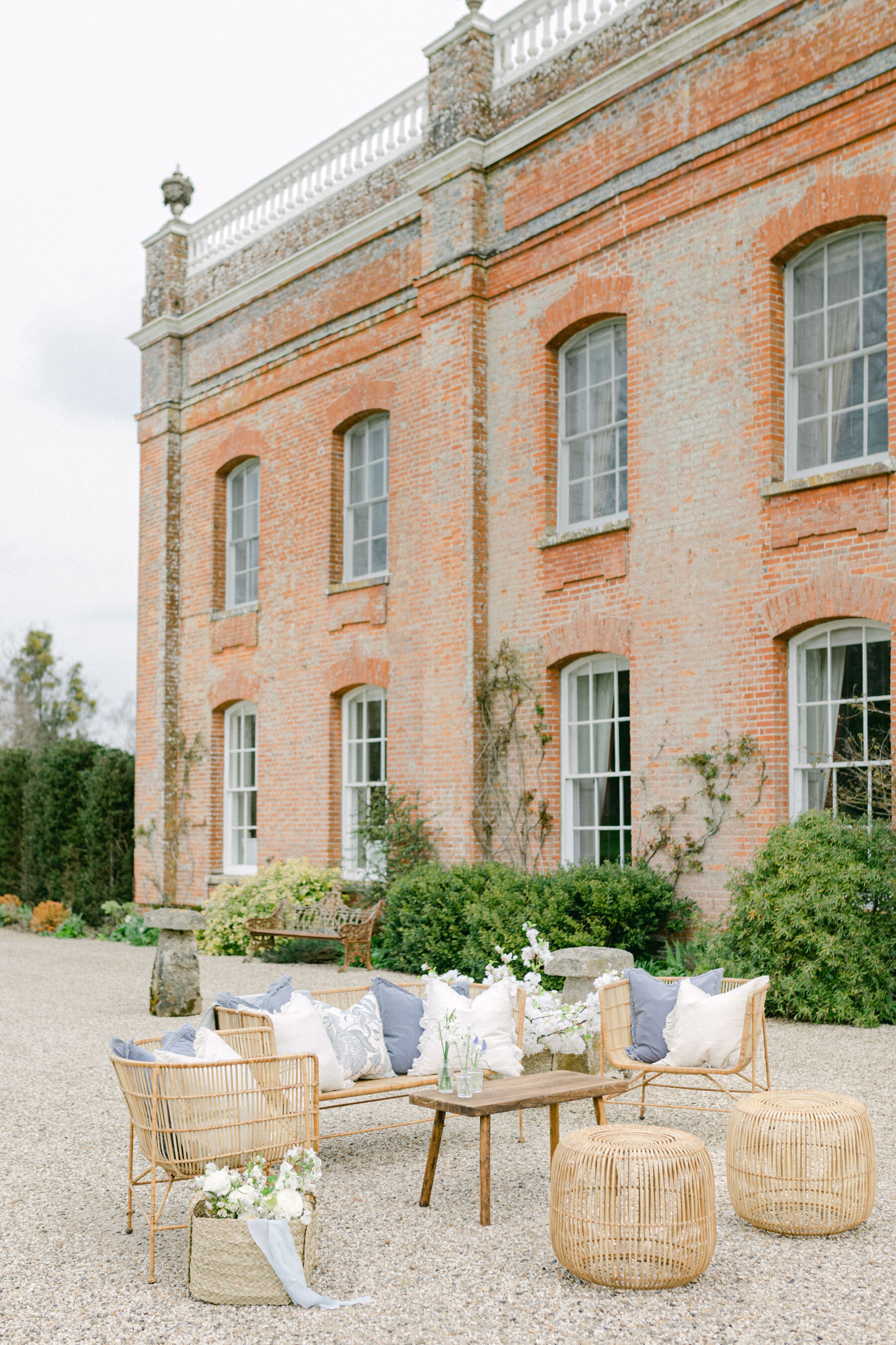 Pale Baby Blue Spring Wedding Inspiration at Avington Park, Featuring Halfpenny London 12 Elegant outdoor whicker furniture at Avington Park wedding venue, Hampshire.