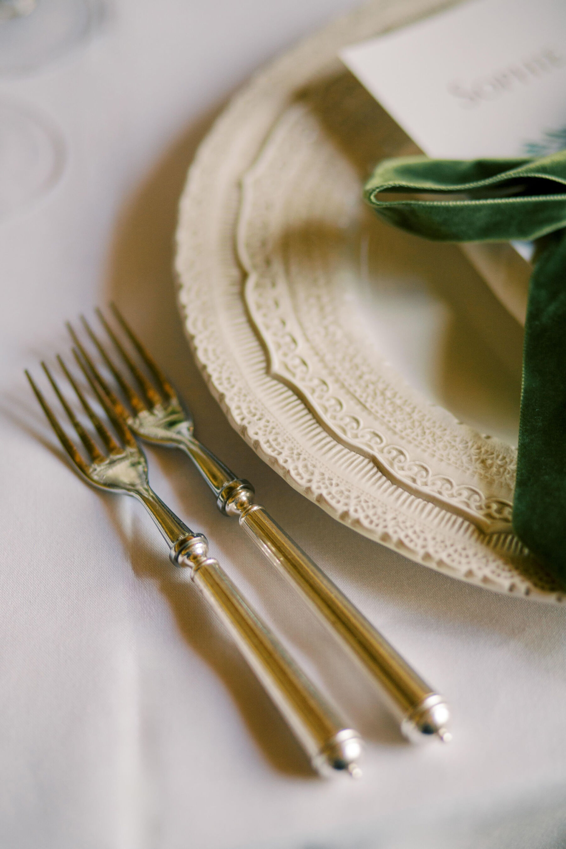 Gothic Architecture Inspired Wedding Styling, at Strawberry Hill House 12 Plates with elegant edging that mirrors the stunning Gothic interior design and architecture of Strawberry Hill House. A green velvet ribbon decorates the plate. Silver cutlery. Helen Warner Photography.