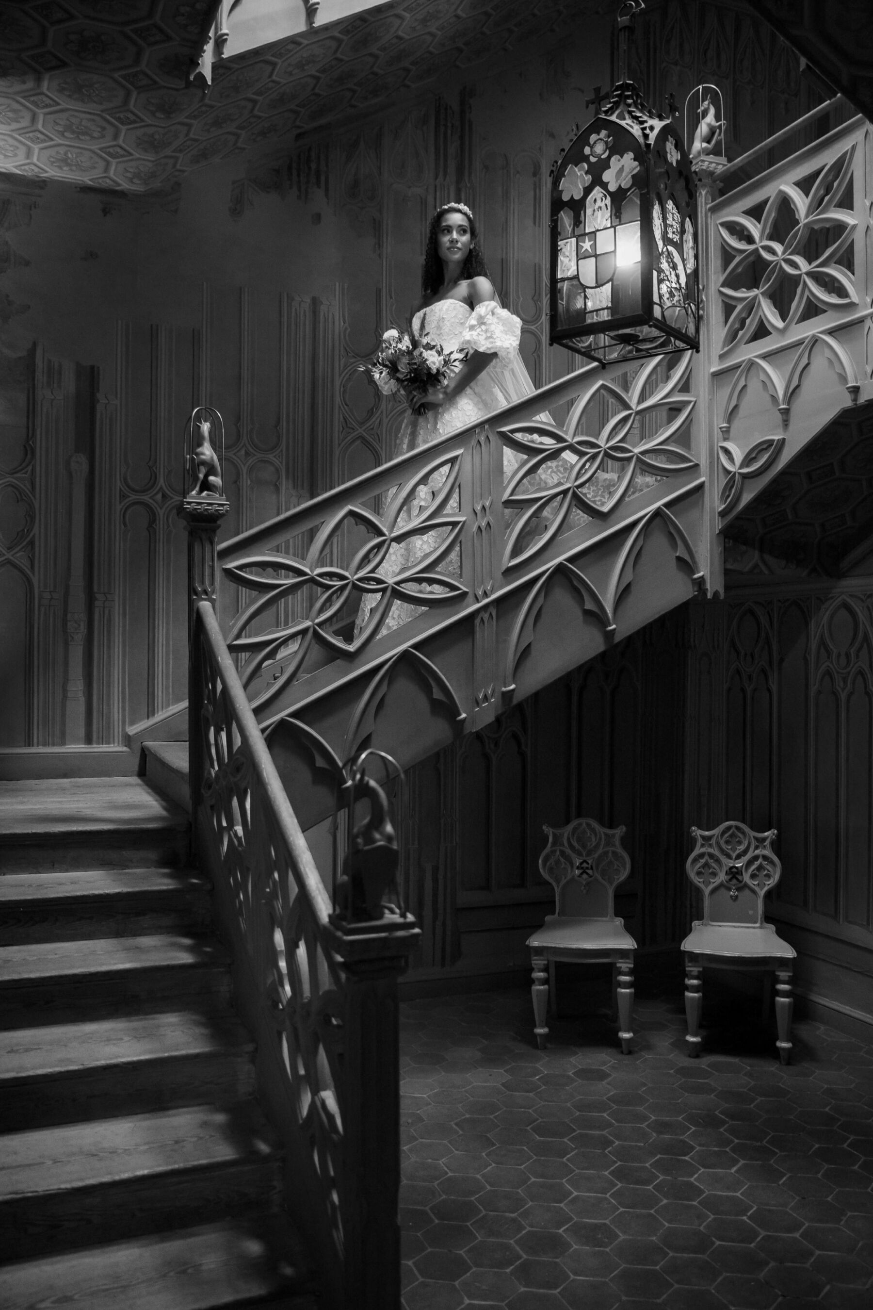 Gothic Architecture Inspired Wedding Styling, at Strawberry Hill House 6 An elegant bride in a puff sleeved wedding dress by Sassi Holford descends the carved wooden staircase at Strawberry Hill House. Helen Warner Photography.