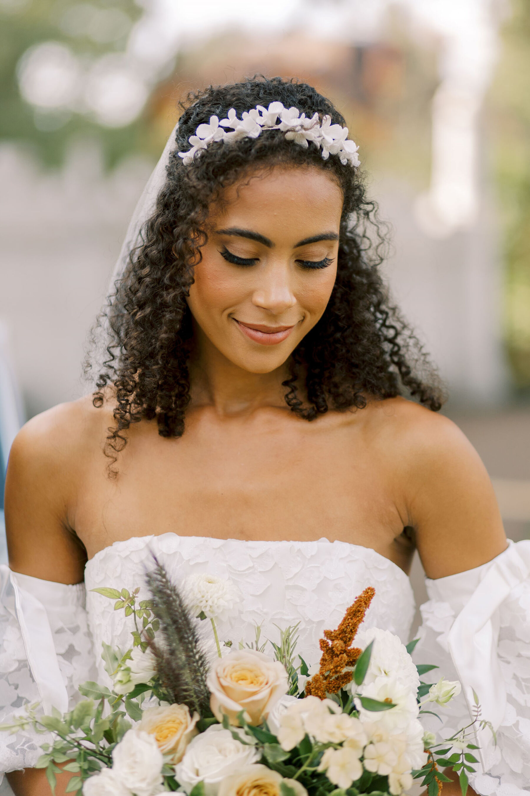 Gothic Architecture Inspired Wedding Styling, at Strawberry Hill House 22 Elegant Black bride with natural curly afro hair looks down towards the hand-tied wedding bouquet she is holding to her chest. Helen Warner Photography.