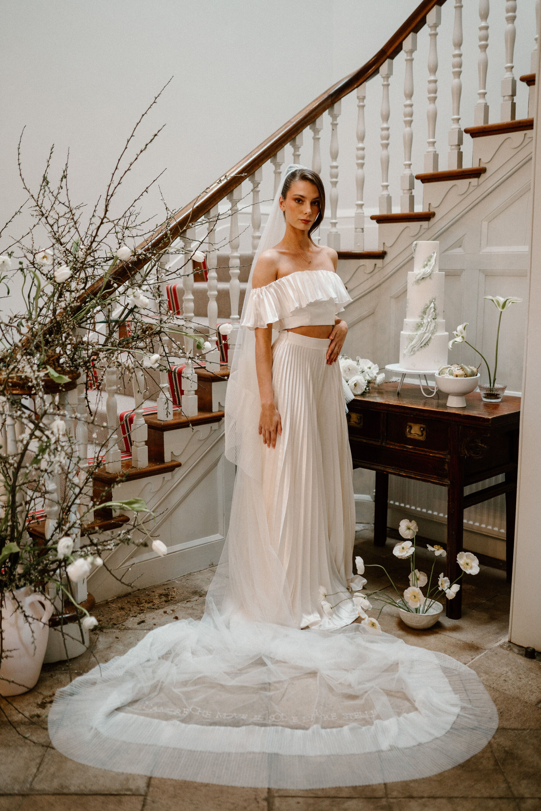 Pleated wedding dress with separate top and skirt by E&W Couture. Embroidered, pleated wedding veil by Rebecca Anne Designs.