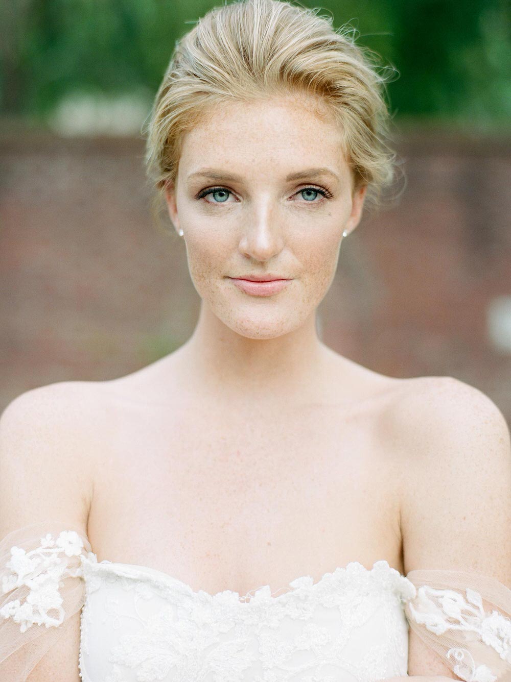 romantic bridal gown with off-the-shoulder sleeves and a bridal updo