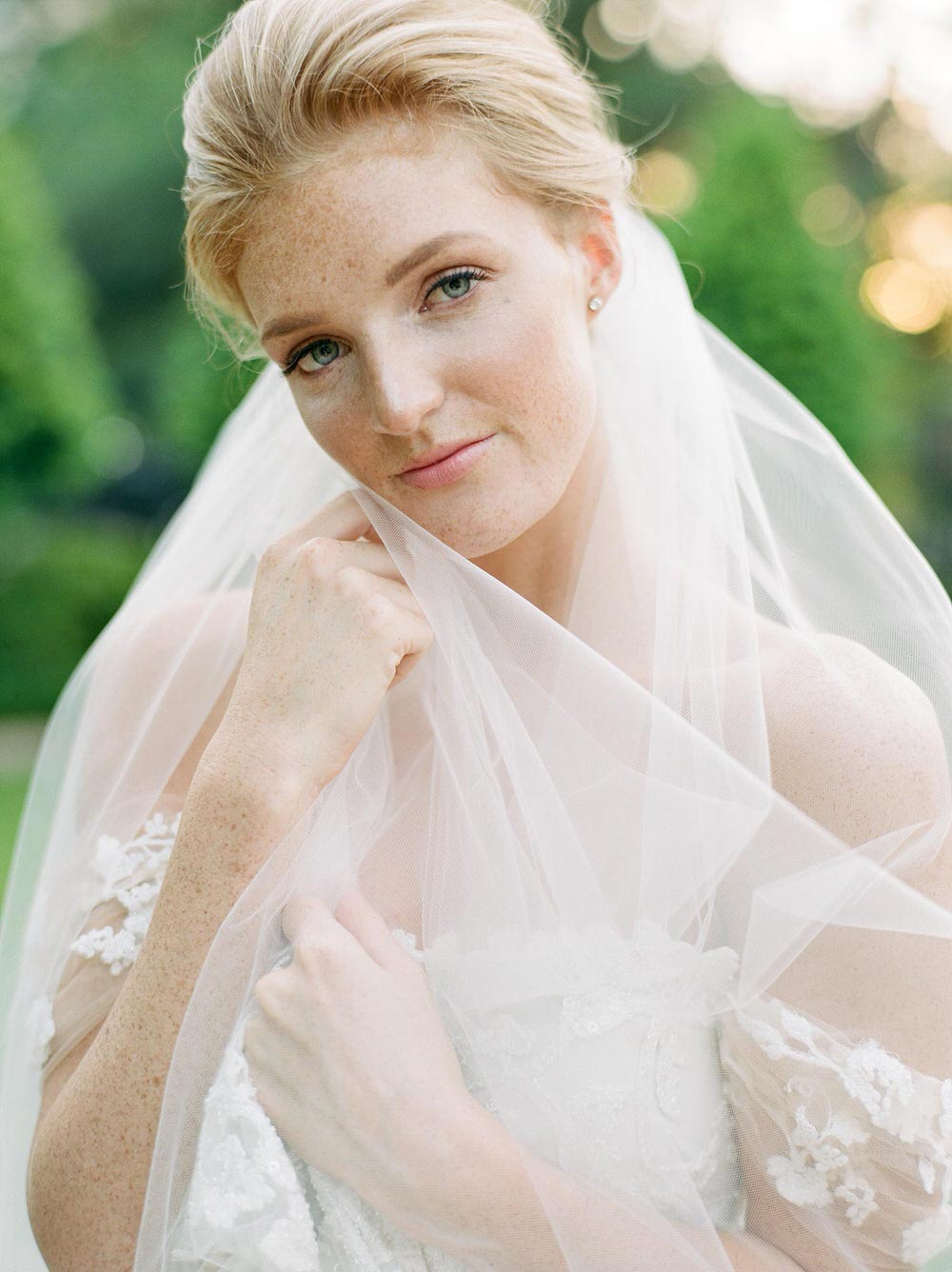 romantic bridal gown with off-the-shoulder sleeves and ethereal bridal veil