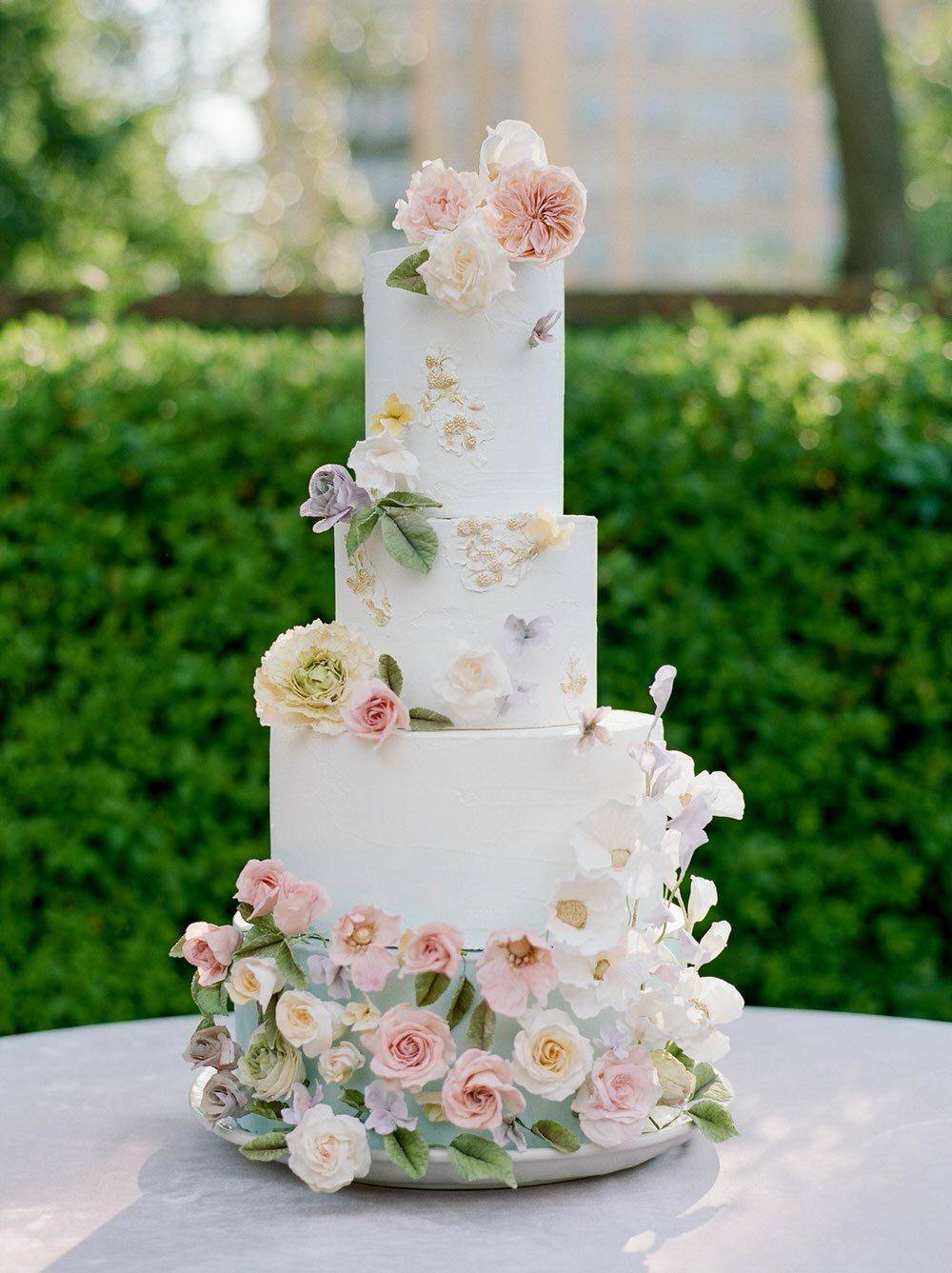 wildflower wedding cake with sugar flowers and pale blue hue