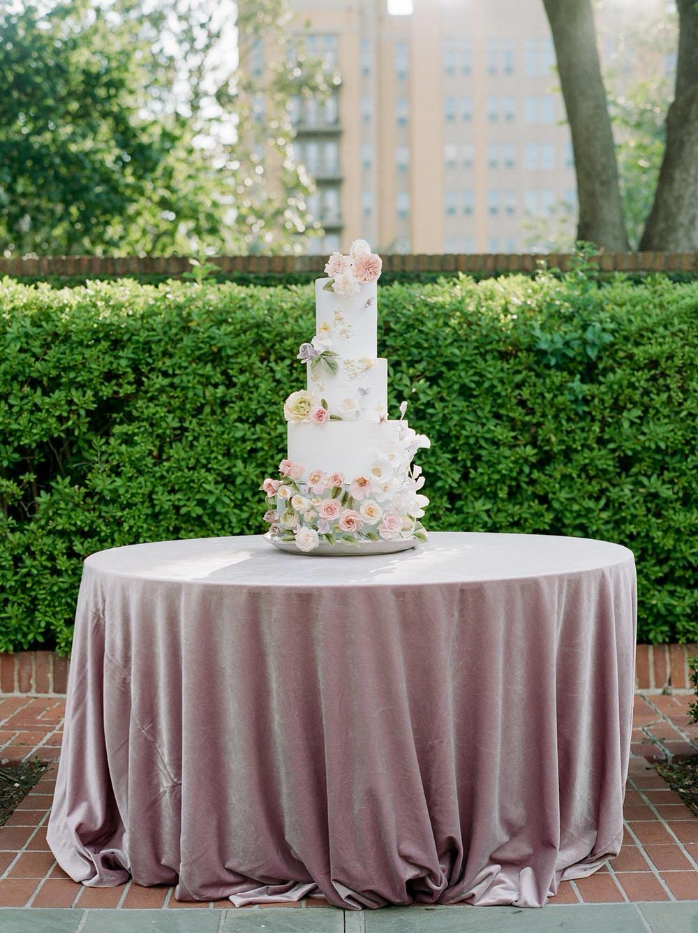 wildflower wedding cake with sugar flowers and pale blue hue