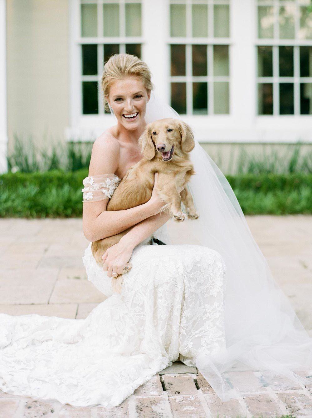 bride holding her smiling puppy