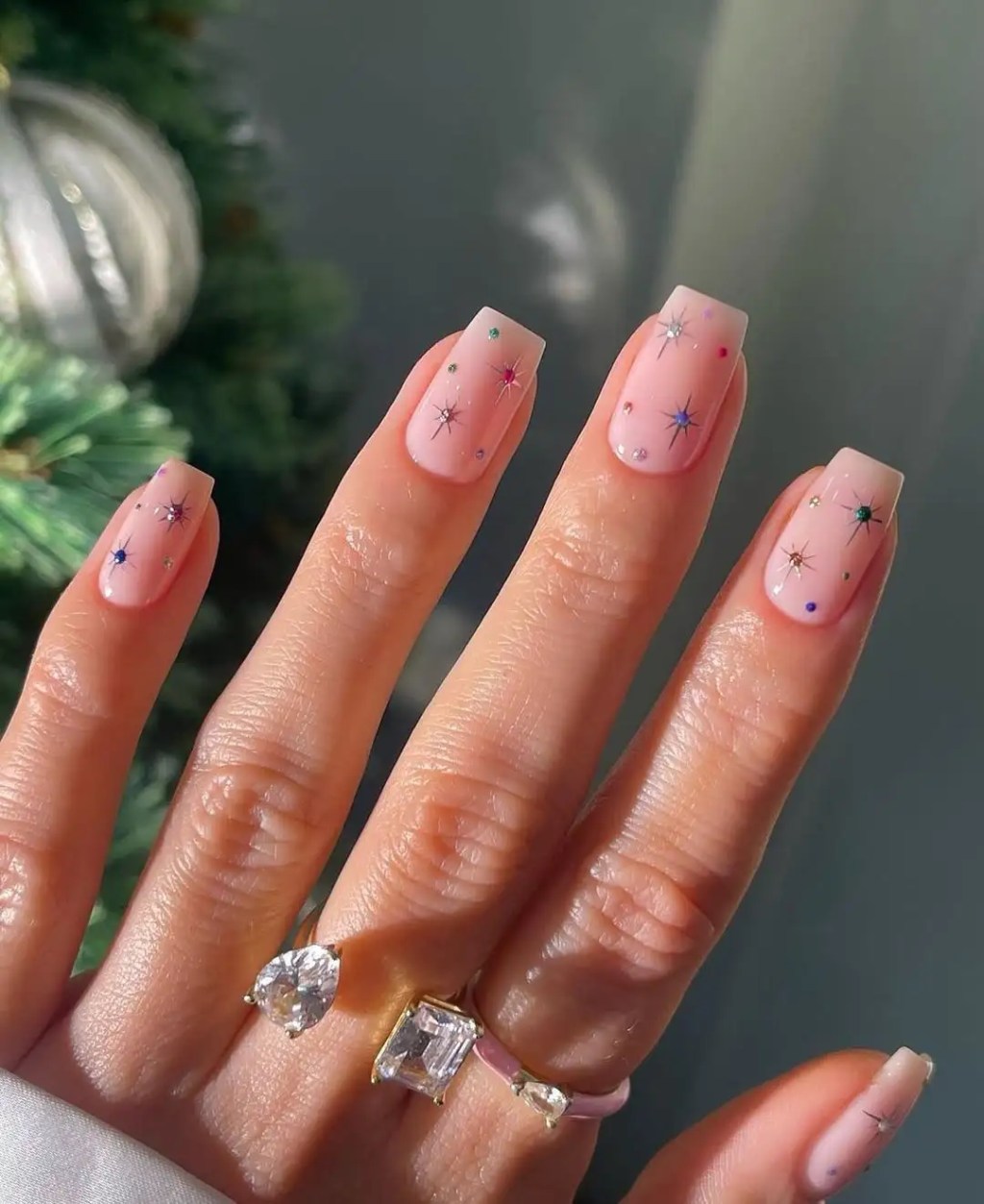 square shaped pink beige nails with colorful sparkly glitter celestial star nail art