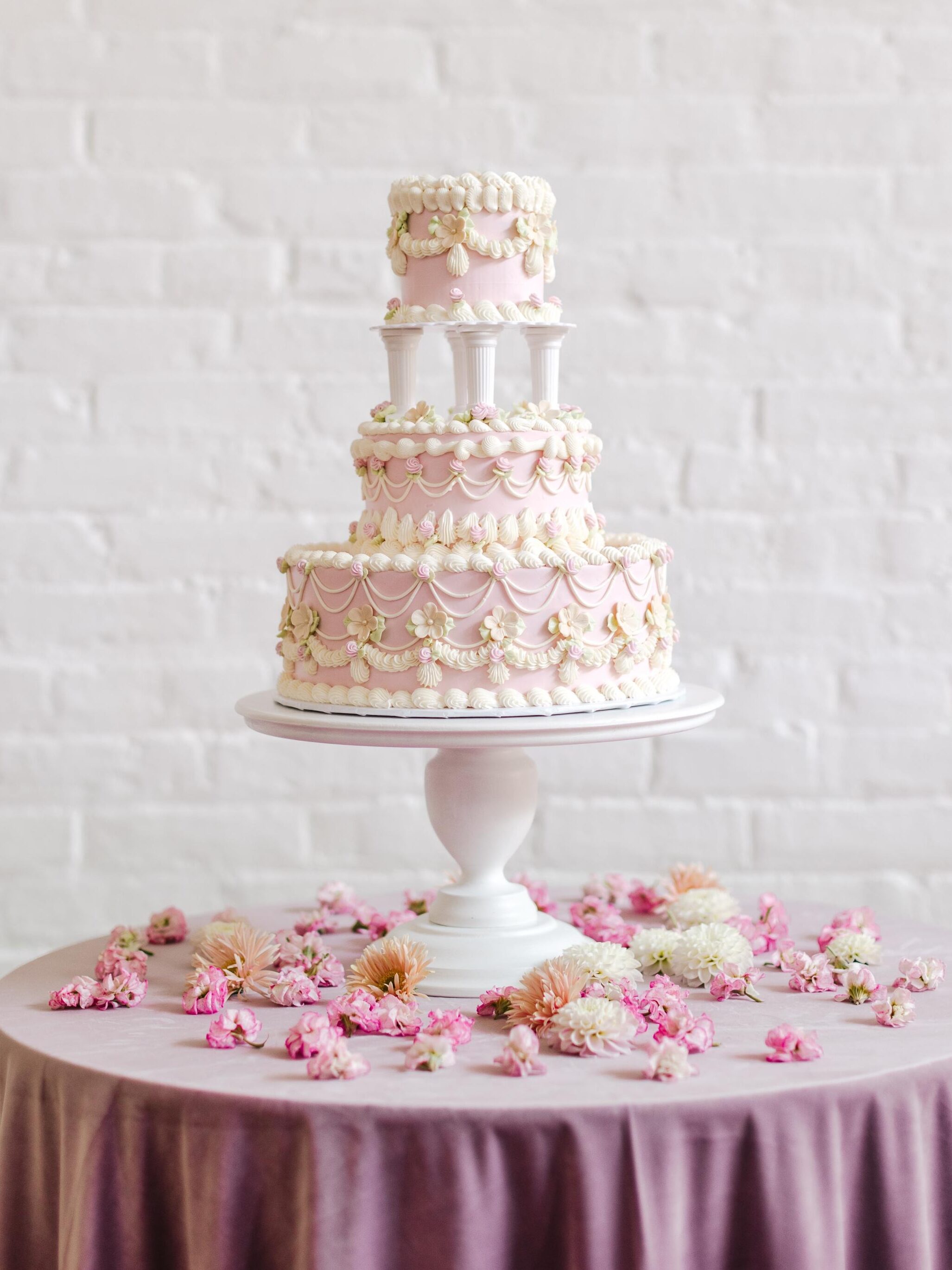 pastel pink three-tier vintage wedding cakes with white daisy flower designs