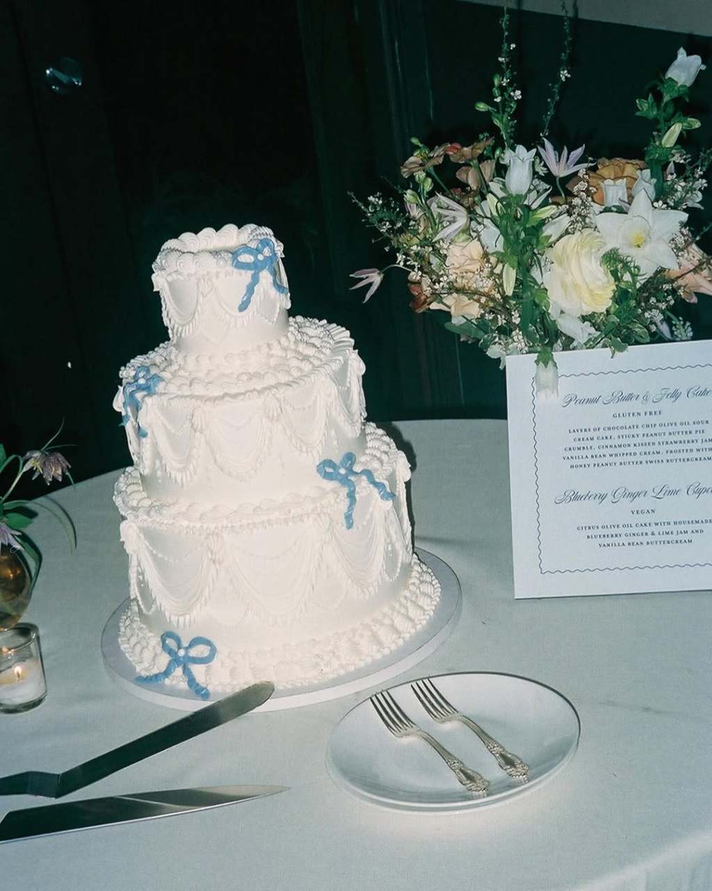 three-tier white vintage wedding cakes with cute blue bows